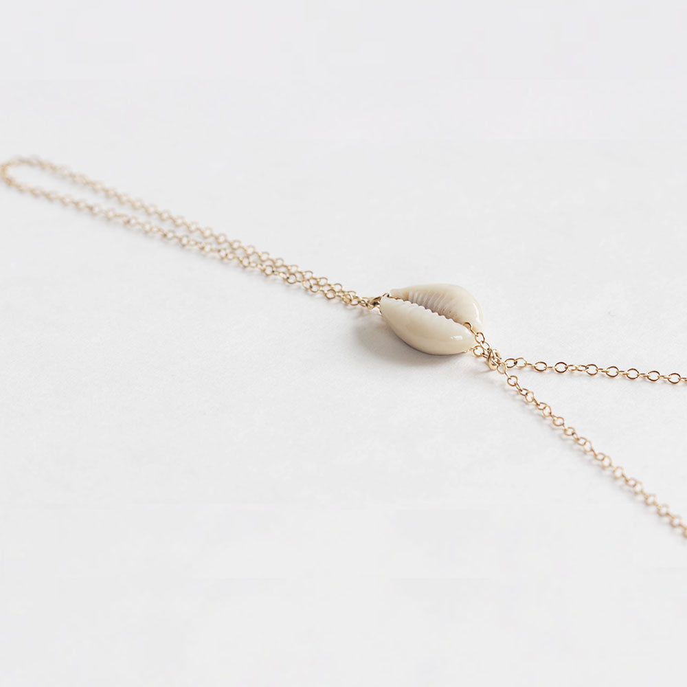 Close up of the cowrie shell handchain by Chains by Lauren.