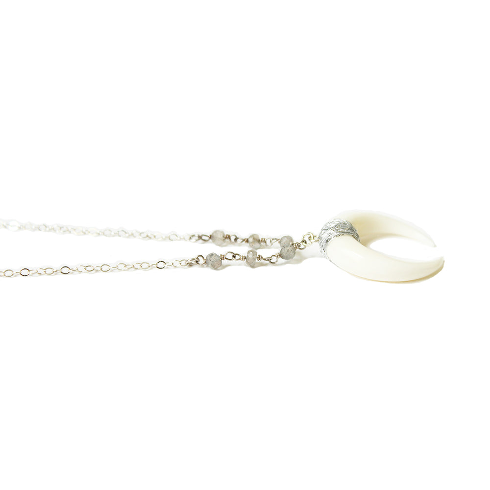 Close up of the white horn necklace in a range of lengths from 18"-24". Made with labradorite stones, and sterling silver chain. Adjustable at the back neck. Handmade. Chains by Lauren