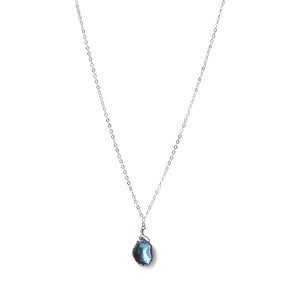 Dive into the world of sophistication with our Black Iridescent Pearl Necklace in sterling silver, a timeless piece that exudes elegance and charm.