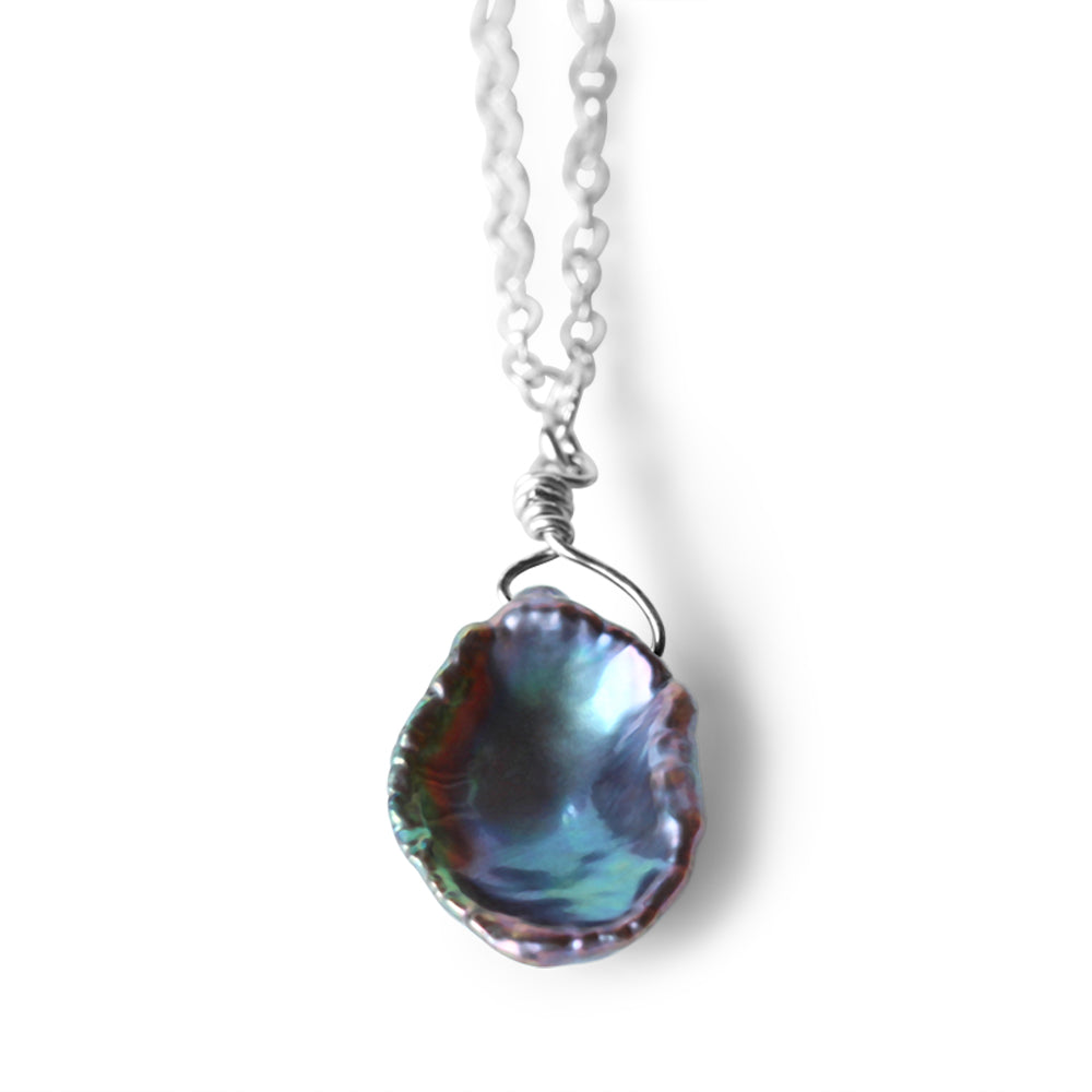 Embrace the timeless beauty of pearls and the gleam of sterling silver, elevating your jewelry collection with our Black Iridescent Pearl Necklace.