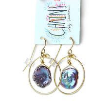 These tiny iridescent pearl hoop earrings are made from 14k gold filled wire and a fresh water pearl. 