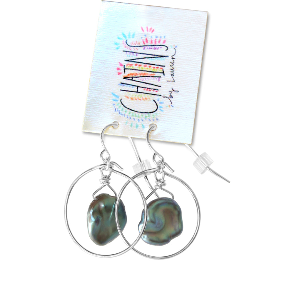 These tiny iridescent pearl hoop earrings are made from sterling silver wire and a fresh water pearl.