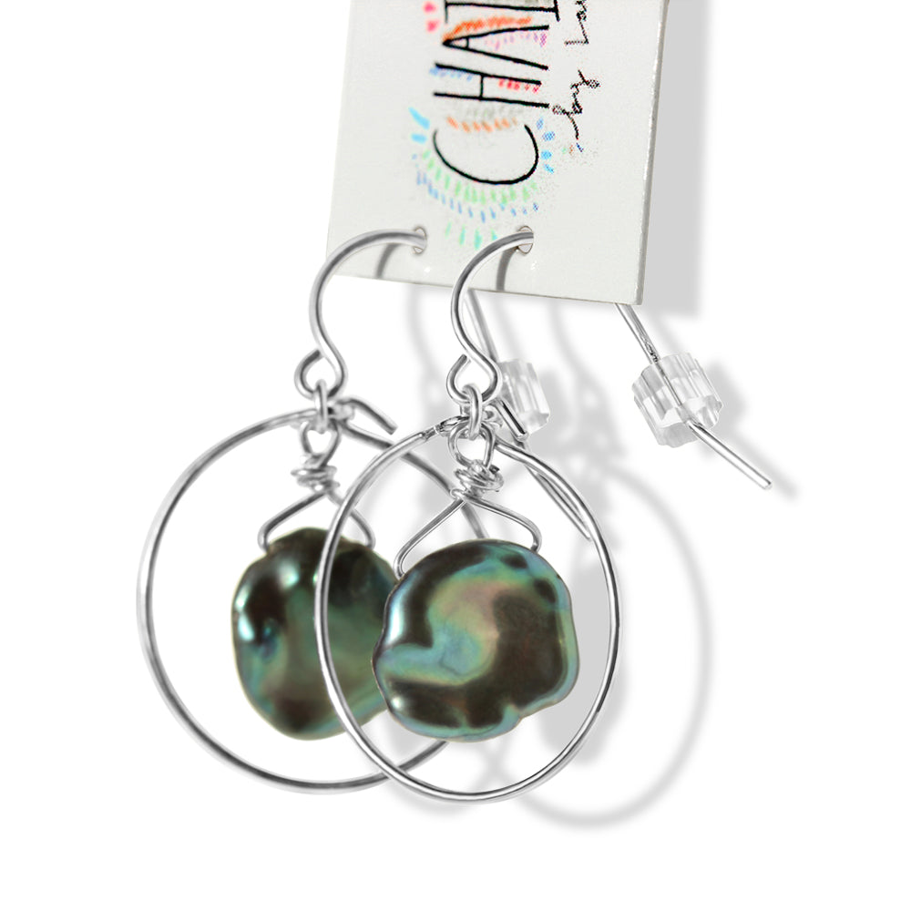 The iridescent pearls are the epitome of elegance, exhibiting a mesmerizing play of colors that catch the light from every angle. 