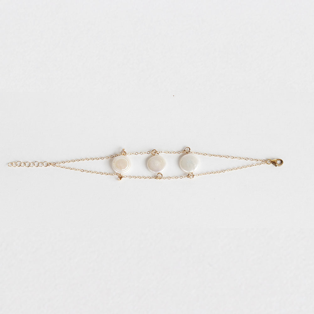 The pearl charm bracelet is made from fresh water pearls and gold fill chain.  Find this jewelry on chainsbylauren.us. Adjustable so one size fits all. Chains by Lauren