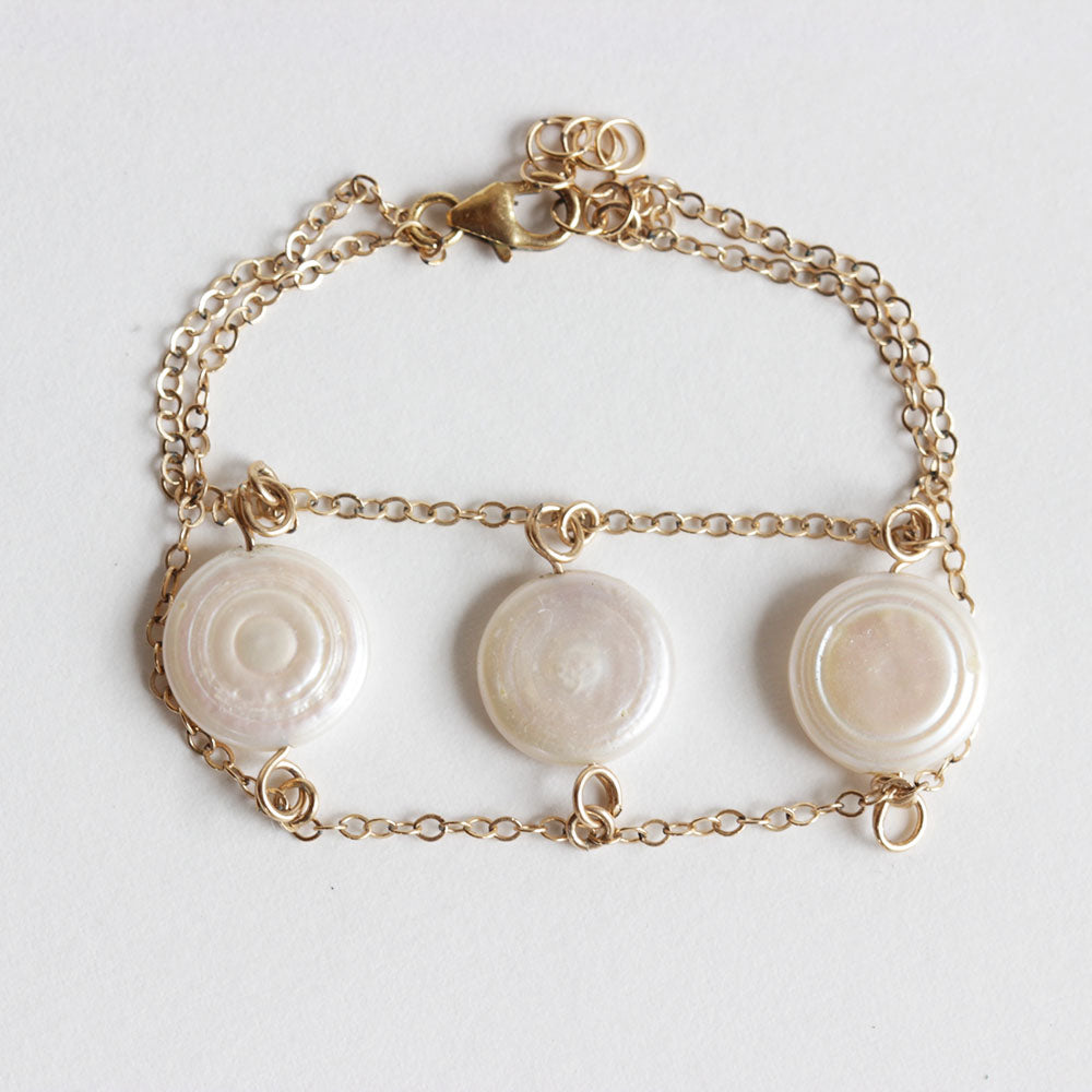The pearl charm bracelet is made from fresh water pearls and gold fill chain.  Adjustable so one size fits all.  Chains by Lauren