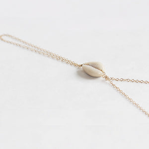 Close up of the cowrie shell handchain by Chains by Lauren.