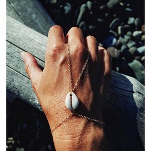 The cowrie shell handchain is perfect for all of you beach ladies!  Made of gold fill and a cowrie shell.  Available in silver as well.  Find this handchain on chainsbylauren.us.