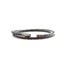 Thin unisex black leather wrap bracelet.  Secures with a magnetic closure and safety lock.  Chains by Lauren