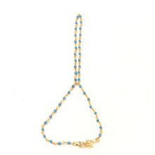 The turquoise handchain made with gold plated wire, a gold filled extension and lobster claw.