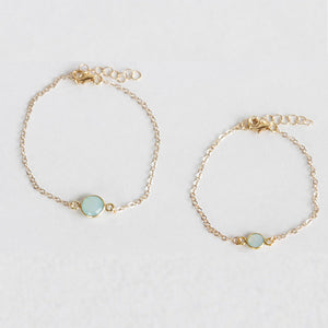 Mother and daughter chalcedony bracelet set. The mother wears the larger stone and the daughter wears the smaller stone. Perfect for mother and daughter jewelry. Found on chainsbylauren.us. Handmade. Chains by Lauren