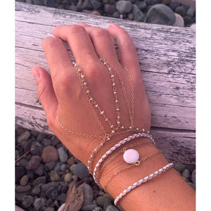 Layered handchain bracelets, charm and leather wrap bracelets found on www.chainsbylauren.us.  Including the pearl charm bracelet.  Made with a fresh water pearl and gold fill chain.  Chains by Lauren.