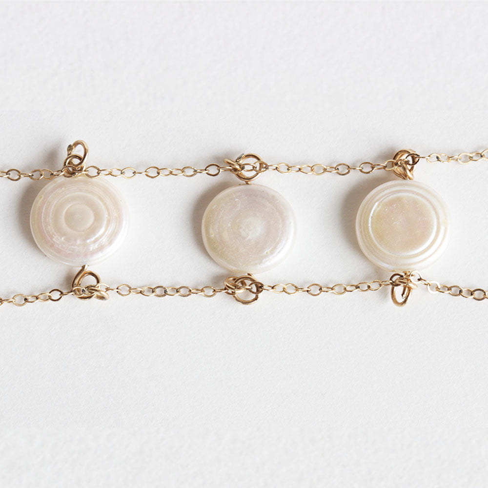 Close up of the pearl charm bracelet.  Made with fresh water pearls and gold fill chain.  Find this jewelry on chainsbylauren.us. Adjustable so one size fits all. Chains by Lauren