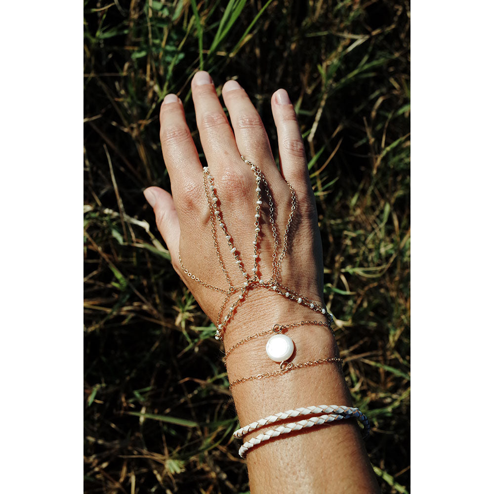 Layered handchain bracelets.  Including the pearl handchain bracelet.  Perfect for layering or wearing alone.  Made with tiny fresh water pearls and gold plated silver wire.  Chains by Lauren