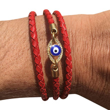 Red wrap evil eye charm bracelet.  Made with leather.  Adjustable so one size fits all.  Handmade.  Chains by Lauren