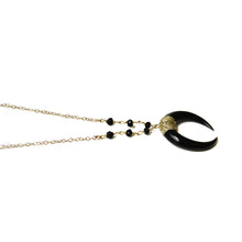 Close up of the black horn necklace in a range of lengths from 18"-24". Made with black spinel beads, and gold fill chain. Adjustable at the back neck. Handmade. Chains by Lauren