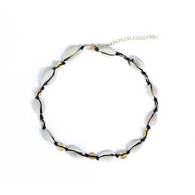 Wear the cowrie necklace as a choker or a double wrap bracelet.  Chains by Lauren