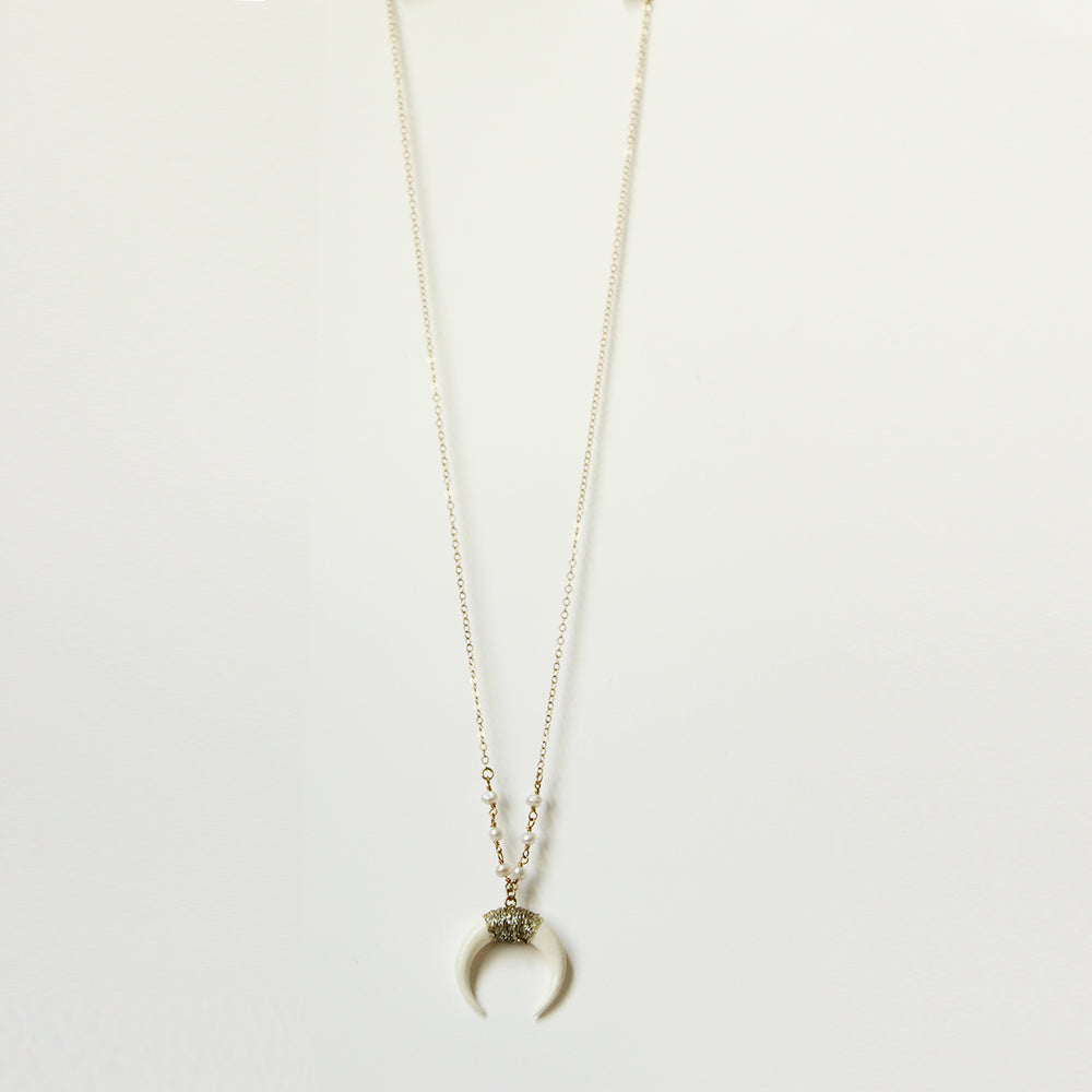 White horn necklace in a range of lengths from 18"-24". Made with pearls, and gold fill chain. Adjustable at the back neck. Handmade. Chains by Lauren