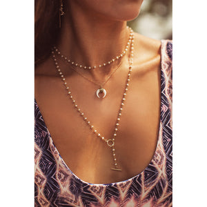 The pearl lariat layered the the boho horn necklace.  Found on chainsbylauren.us.  Handmade.  Chains by Lauren