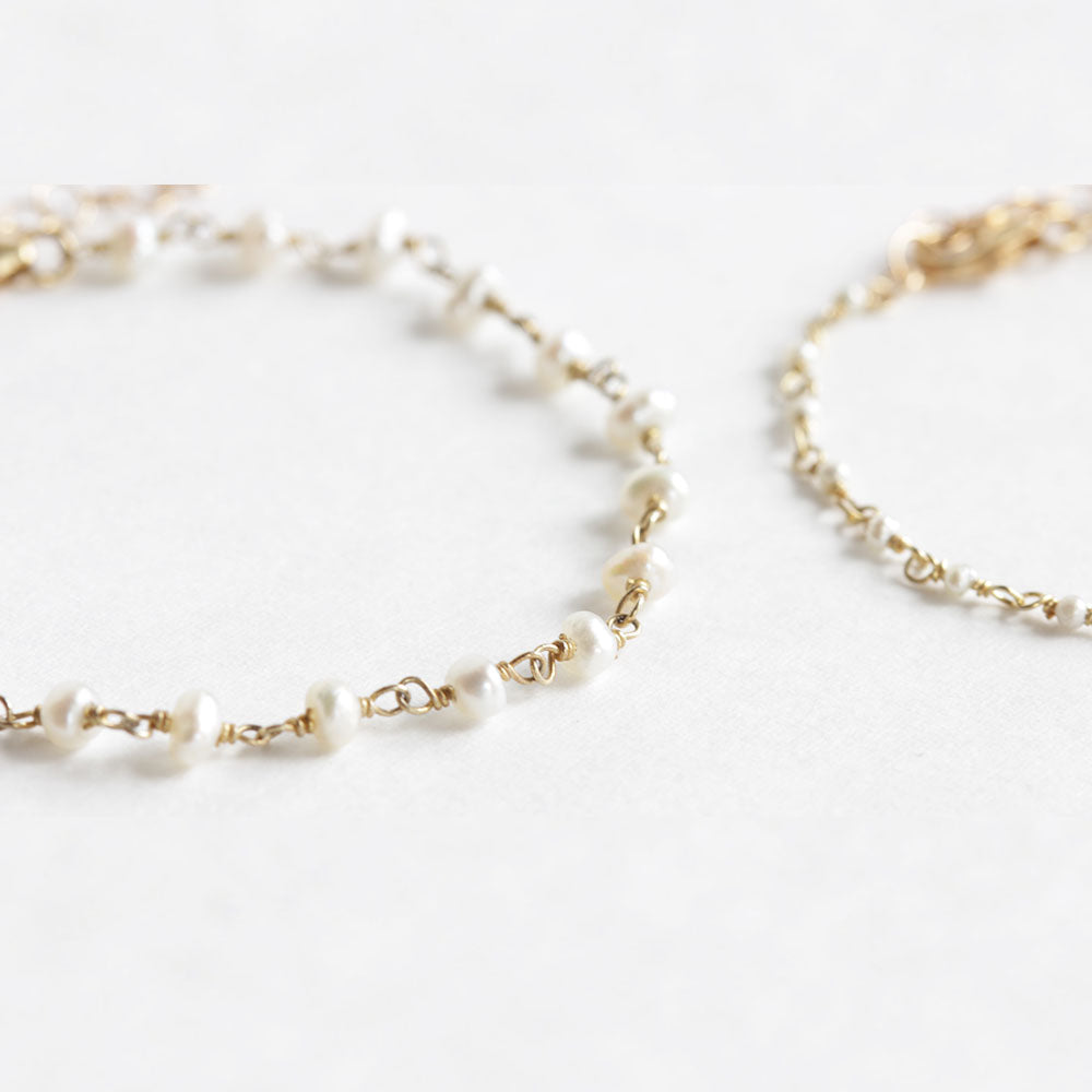 Close up of the momma and me pearl bracelet set made from fresh water pearl.  The mother wears the larger pearls and the daughter wears the baby pearls.  Choose from a rang of sizes for a 1 to 10 year old.  Handmade with love.  Chains by Lauren