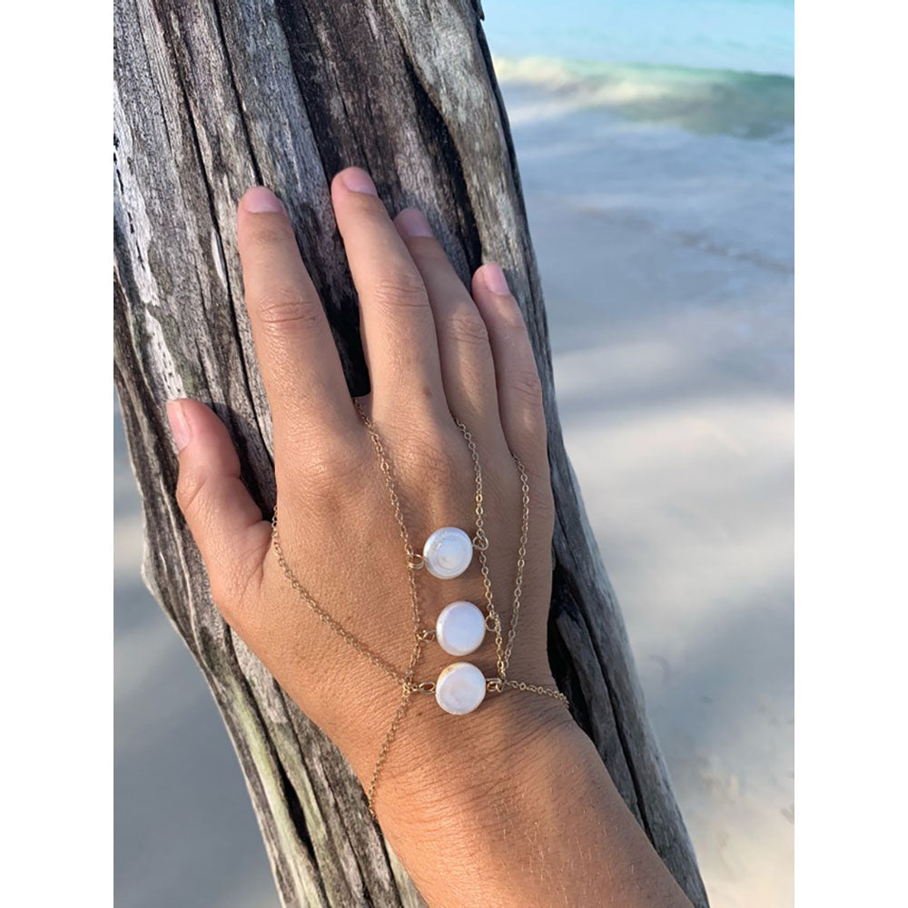 This statement pearl hand bracelet is made from fresh water pearls and gold fill chain.