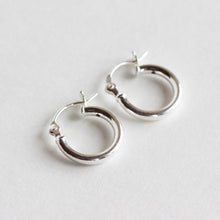 Tiny sterling silver hoops.  Available at chainsbylauren.us.