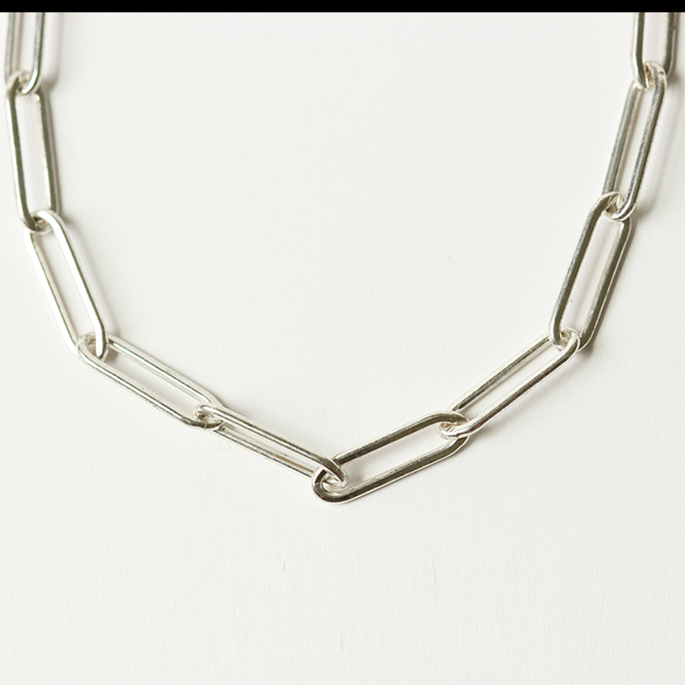 Close up of the silver paper clip chain charm bracelet.  Chains by Lauren